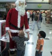 Nathanael and an electronic Santa at WalMart